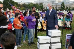 Sen. Bob Casey stands in front of a group of 30 people with a box of stories from careworkers.